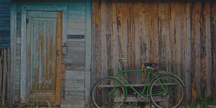 old house with bicycle leaned up against it