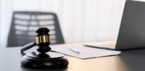 Black wooden gavel hammer on empty law firm or lawyer office background as justice and the legal system for lawyer and judge, Symbolize authority and fairness in trials and auctions. Equilibrium
